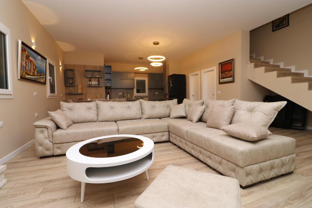 a living room with a couch and a coffee table at Vila Mario Himare in Himare