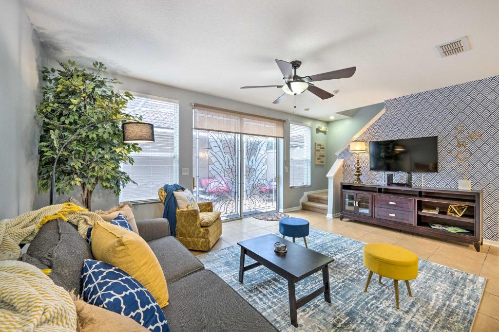 a living room with a couch and a tv at 15 Mi to Disney Kissimmee Townhome with Patio in Kissimmee