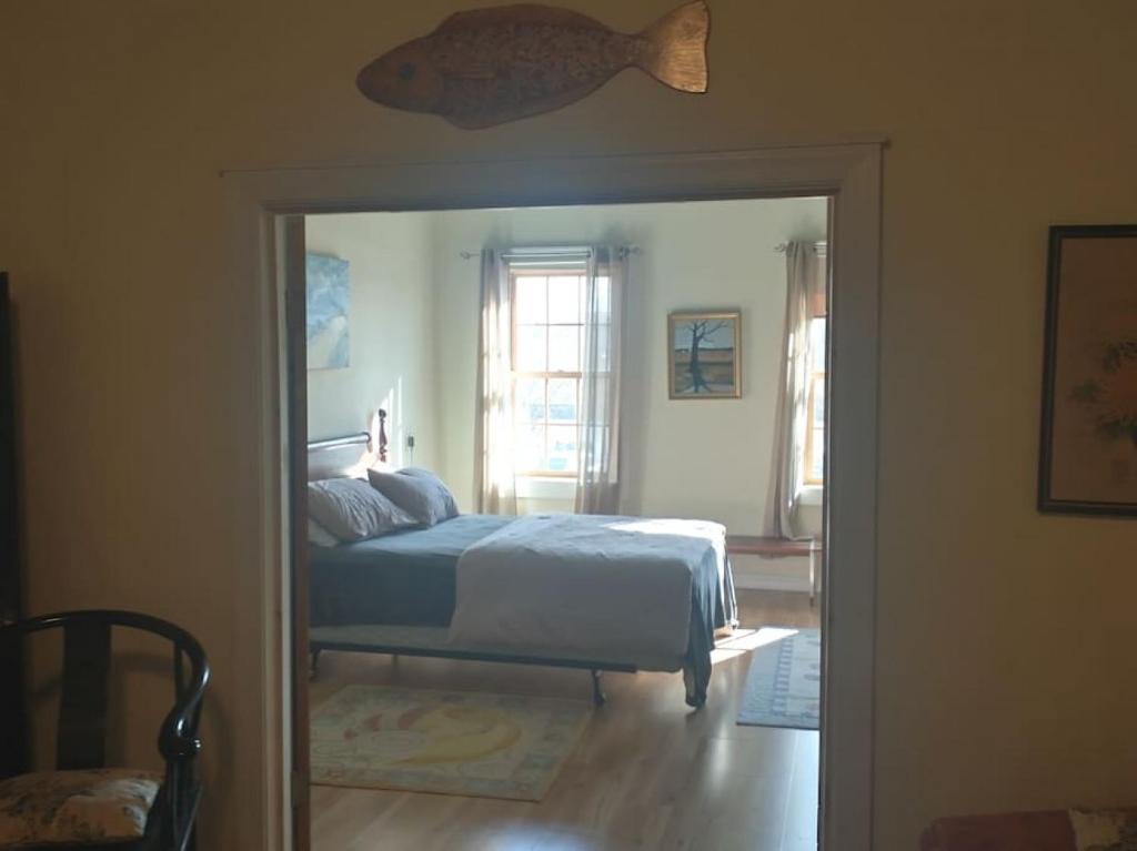 a bedroom with a bed and a large doorway at Loft Apartment w River Views in Salisbury
