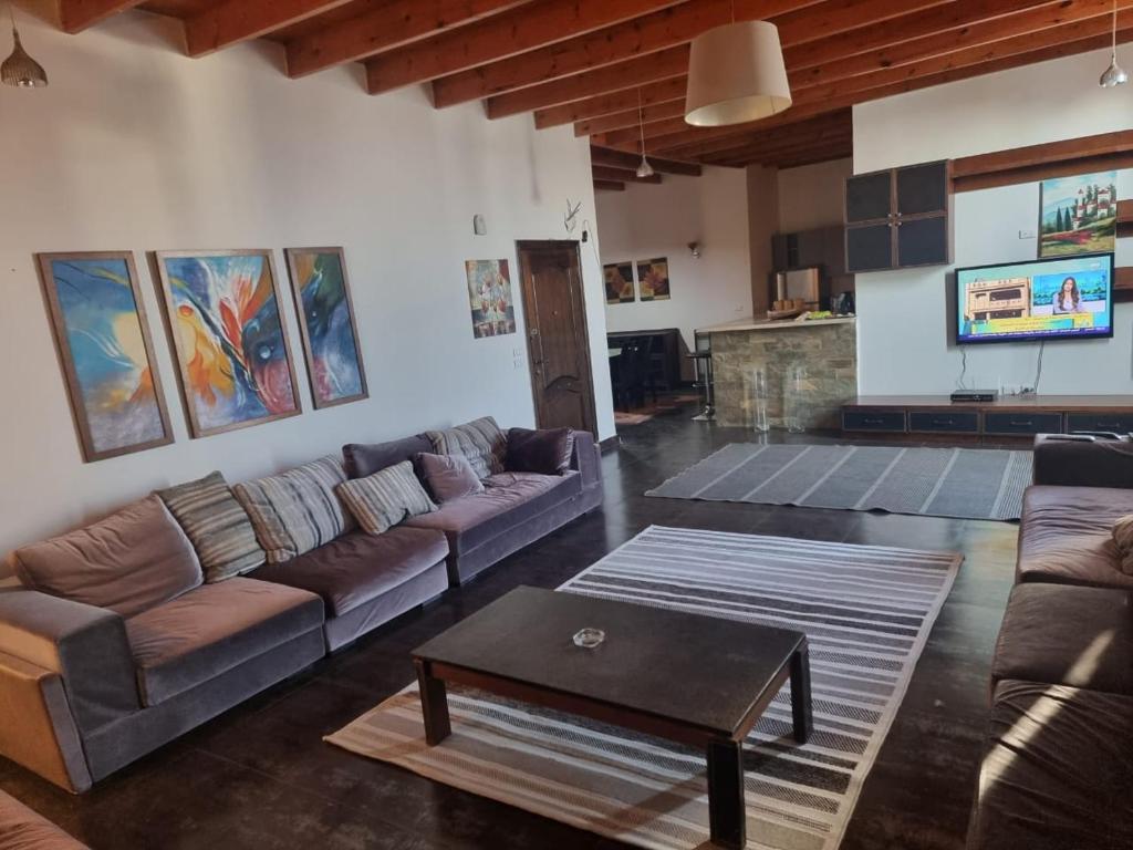 a living room with couches and a coffee table at Askyhomes in Hurghada