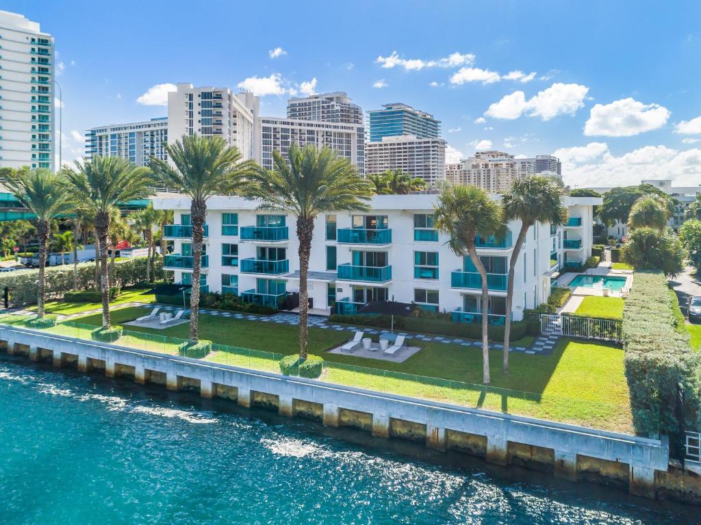 an aerial view of a resort with palm trees and a body of water at Beach Haus Bal Harbour in Miami Beach