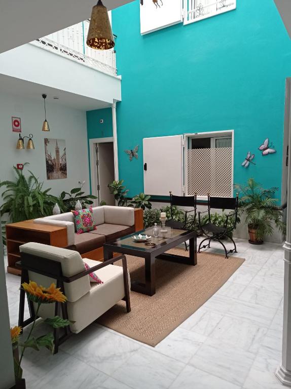 a living room with a couch and a table at Hostal Fabiola in Seville