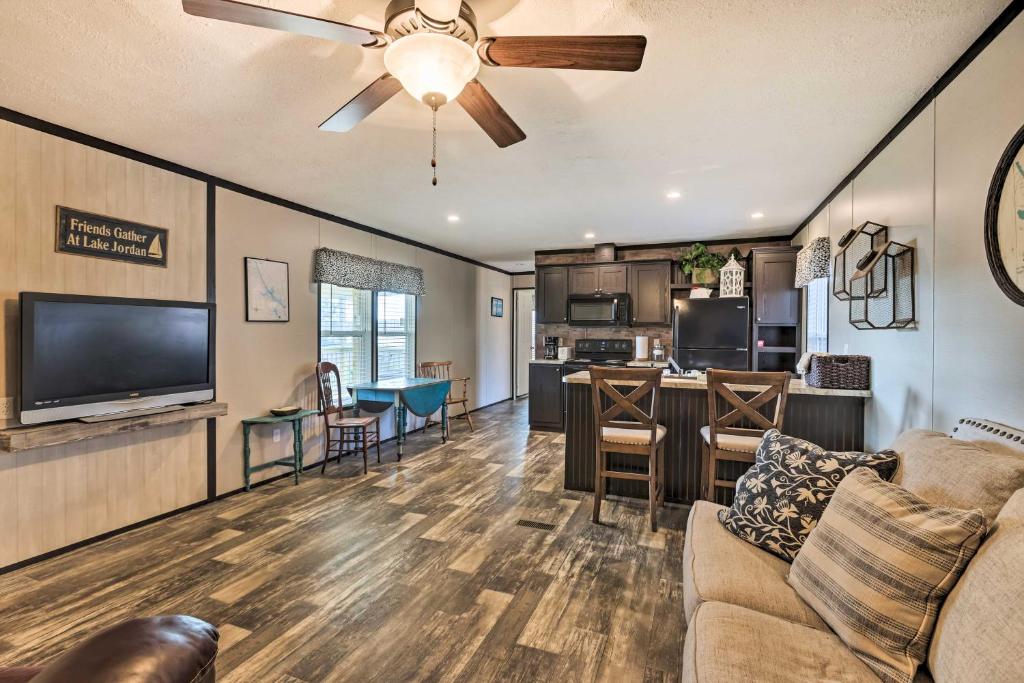 a living room with a couch and a flat screen tv at Lakefront Wetumpka Escape with Furnished Deck! in Wetumpka