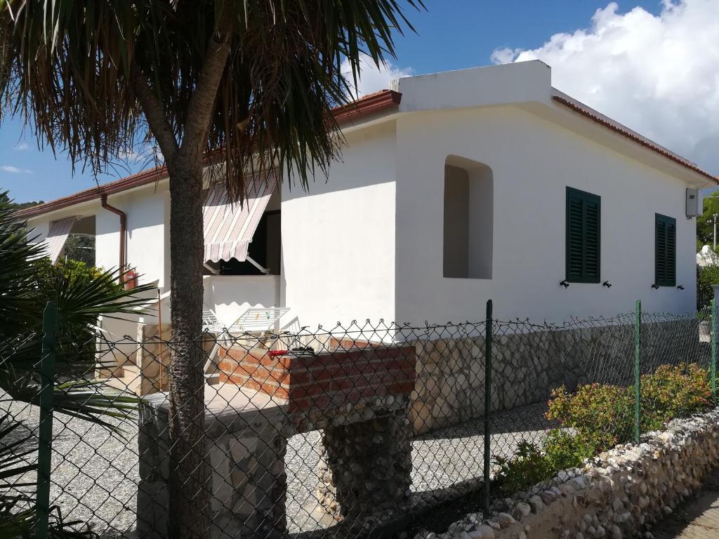 a white house with a fence in front of it at Villini Giovanna Disanti in Vieste