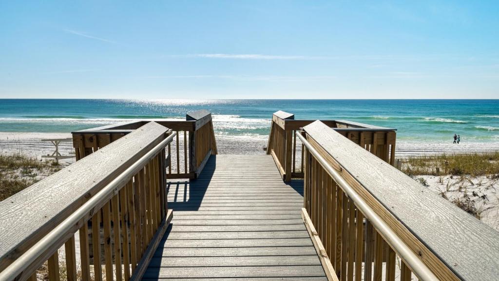 a wooden boardwalk to the beach with the ocean at Sea Haunts 1A in Santa Rosa Beach