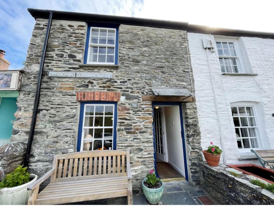 a stone house with a bench in front of it at Waypast, Port Isaac Bay Holidays in Port Isaac