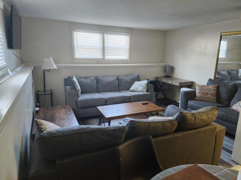 a living room with a couch and a table at Modern Cozy two bedroom apartment with off-street Parking in Worcester