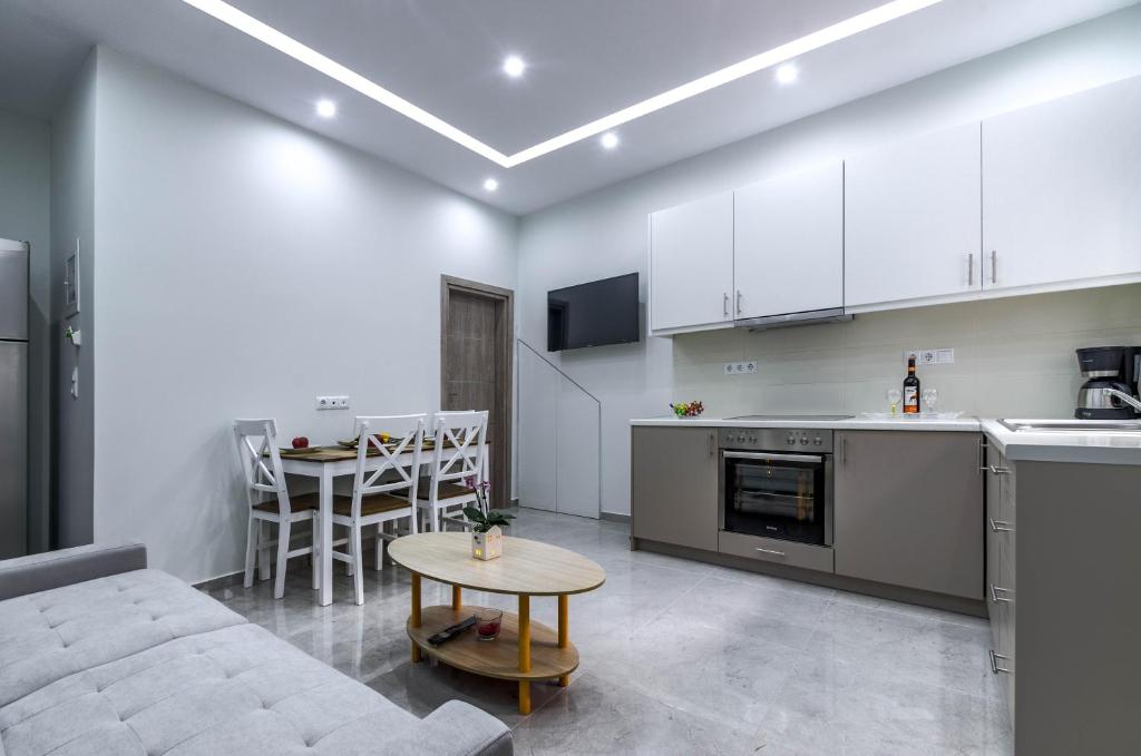uma cozinha e sala de estar com um sofá e uma mesa em Renovated 2BD house close to Pireus port em Piraeus