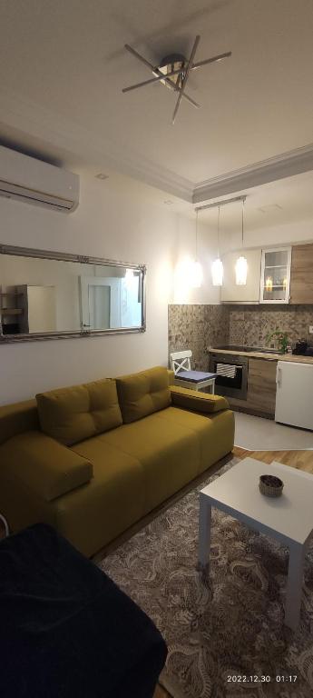 a living room with a couch and a table at Cozy place in Trebinje