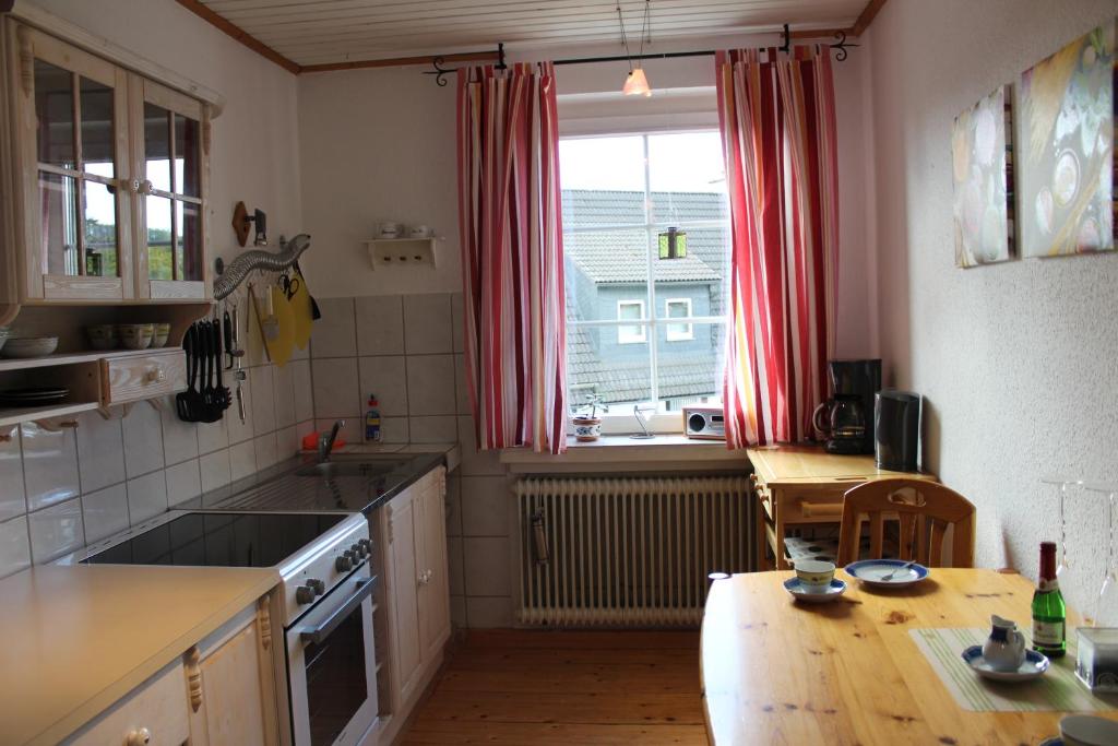 a kitchen with a table and a sink and a window at Ferienwohnung an der Hundem in Kirchhundem