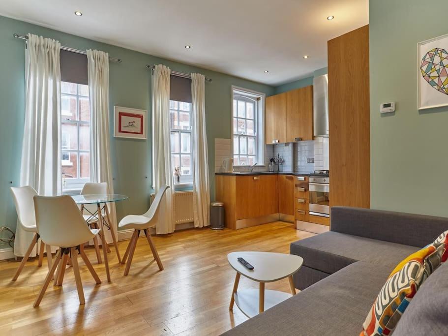 a living room with a couch and a table at (Oxford Street - Piccadilly Circus) Apartment Central London in London