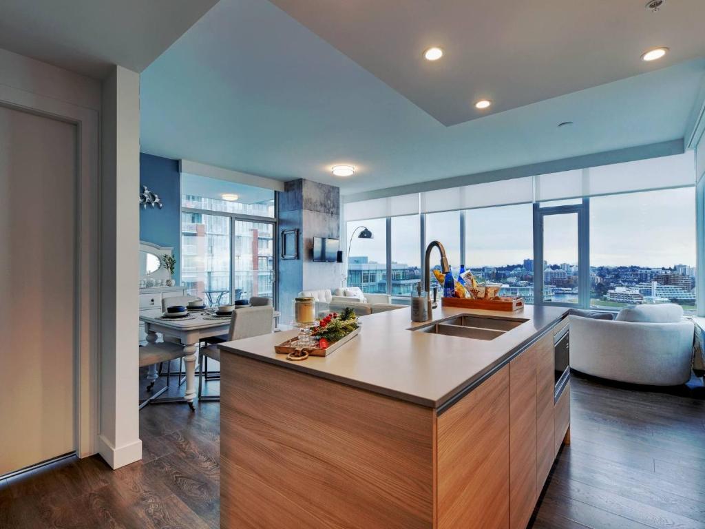 a kitchen with a sink and a large window at Admiral's Anchor by IRIS PROPERTIES! in Victoria