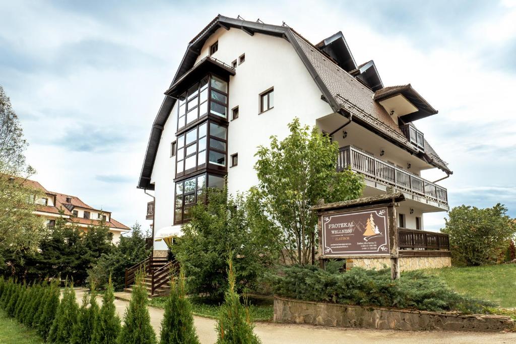 a building with a sign in front of it at Protekal Wellness & SPA in Zlatibor