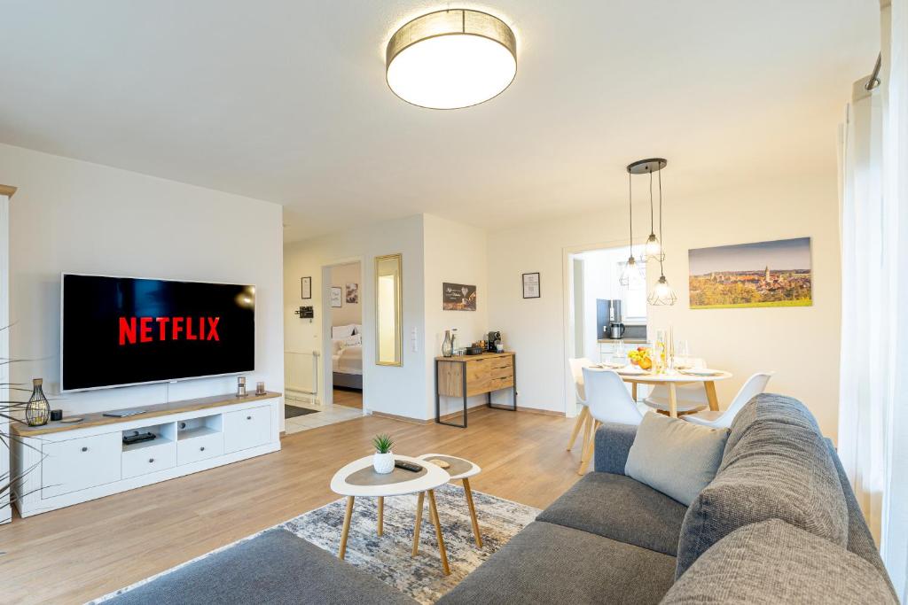 a living room with a couch and a tv at INhome: Garten - Terrasse - Parkplatz - Netflix in Kirchberg an der Jagst