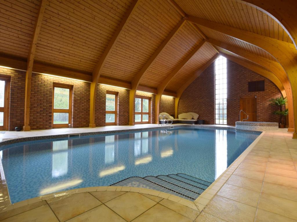 a large swimming pool in a building with a ceiling at Solway in Chester