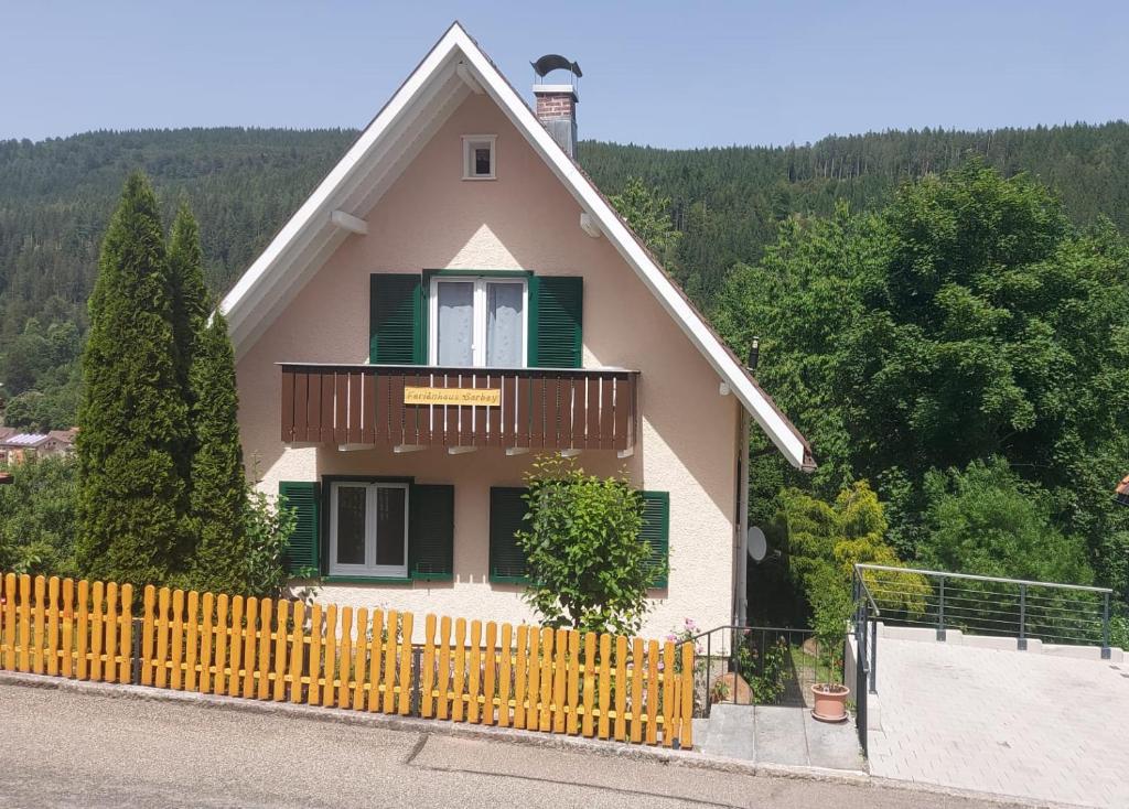 a house with a wooden fence in front of it at Ferienhaus Barbey in St. Blasien