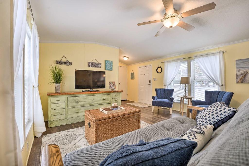 a living room with a couch and a flat screen tv at Charming South Haven Home - Great Location! in South Haven