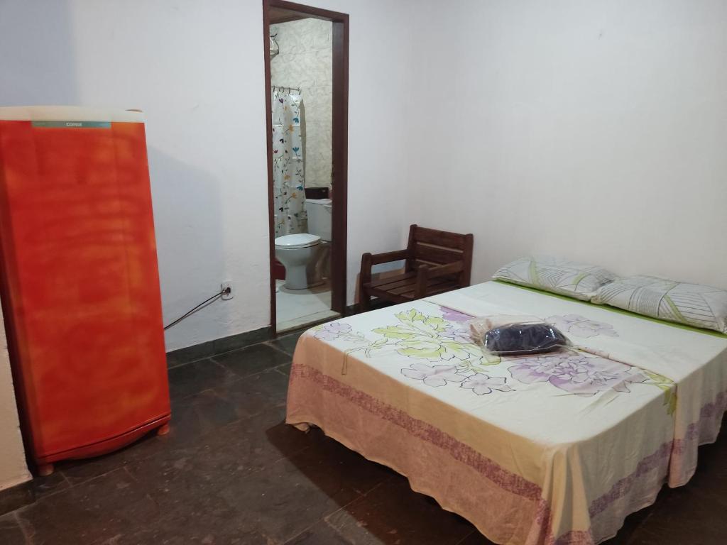 a bedroom with a bed with a purse on it at Mangue House 2 in Barra de Guaratiba