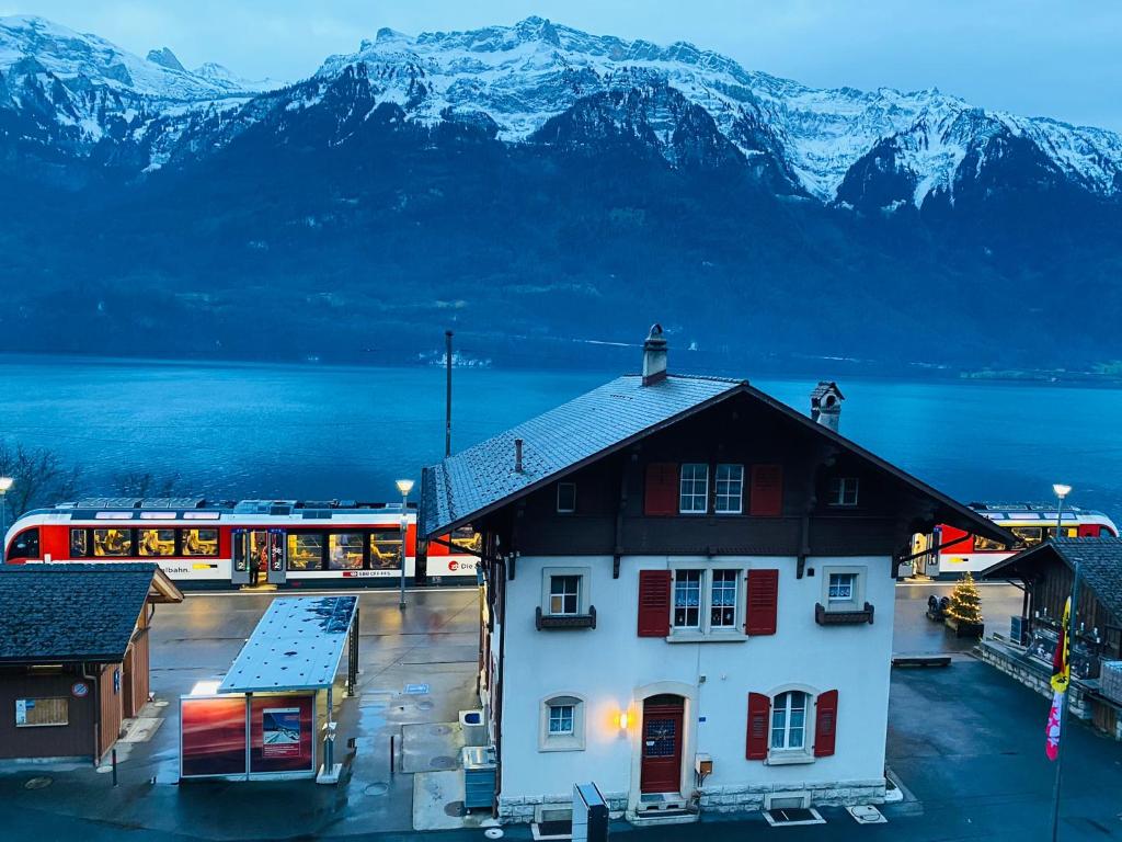 a train station with a building in front of a mountain at Lake View Residence - 20 in Niederried