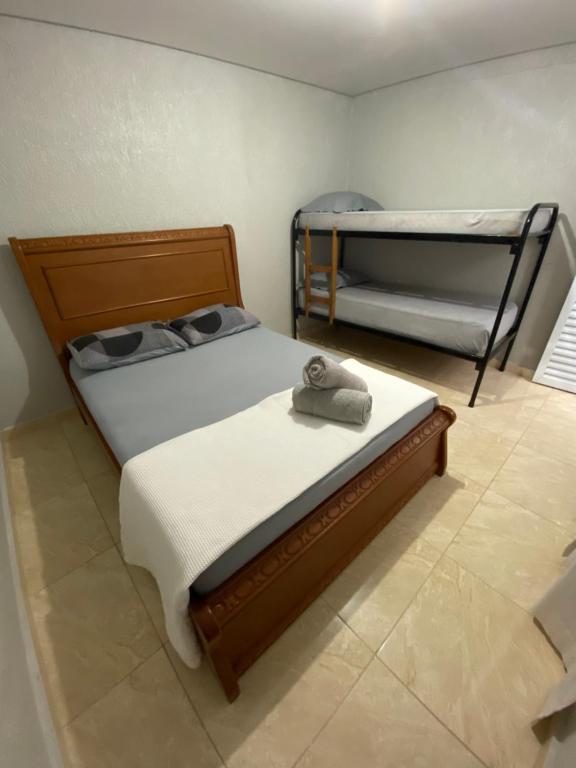 a bedroom with two bunk beds with a towel on it at Casa Guarujá próx. Balsa Santos in Guarujá