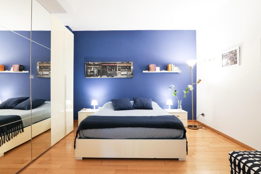 a bedroom with blue walls and a large bed at Chiara Guest House - Nuova Metro blu in Milan