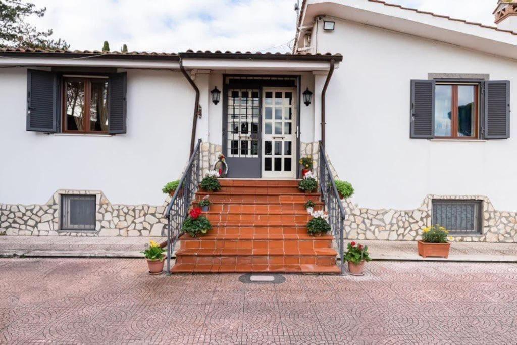 Casa blanca con una escalera que conduce a una puerta en Villa Marisol, en Cesano