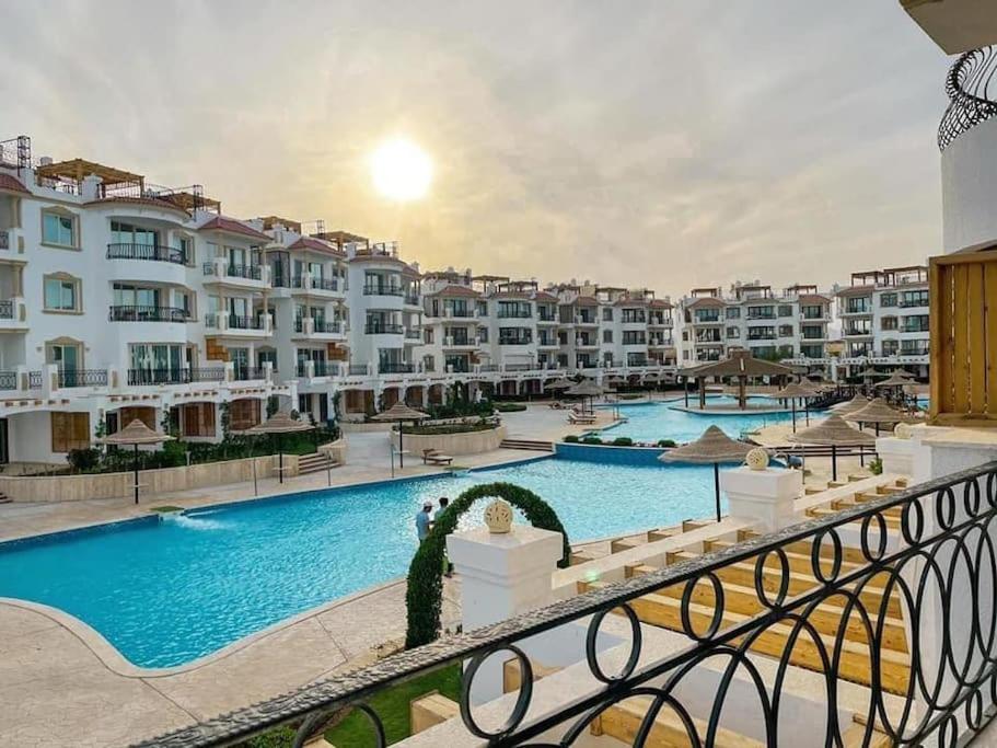 a view from the balcony of a resort with a swimming pool at Sharm Hills Resort - 2Bedroom with Pool View and Beach Access in Sharm El Sheikh