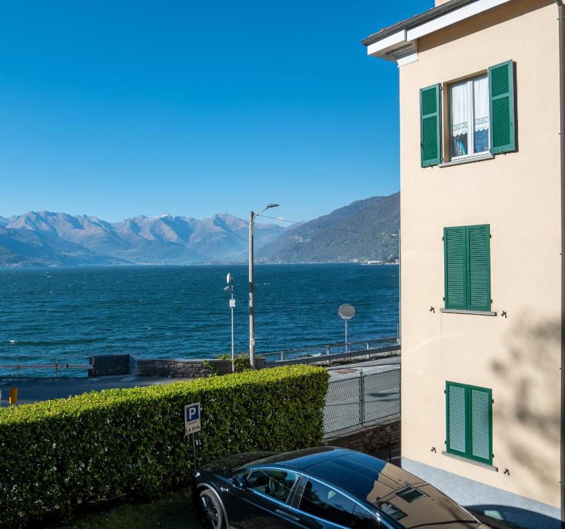 a car parked next to a building with a view of the water at Casa ORI in Perledo