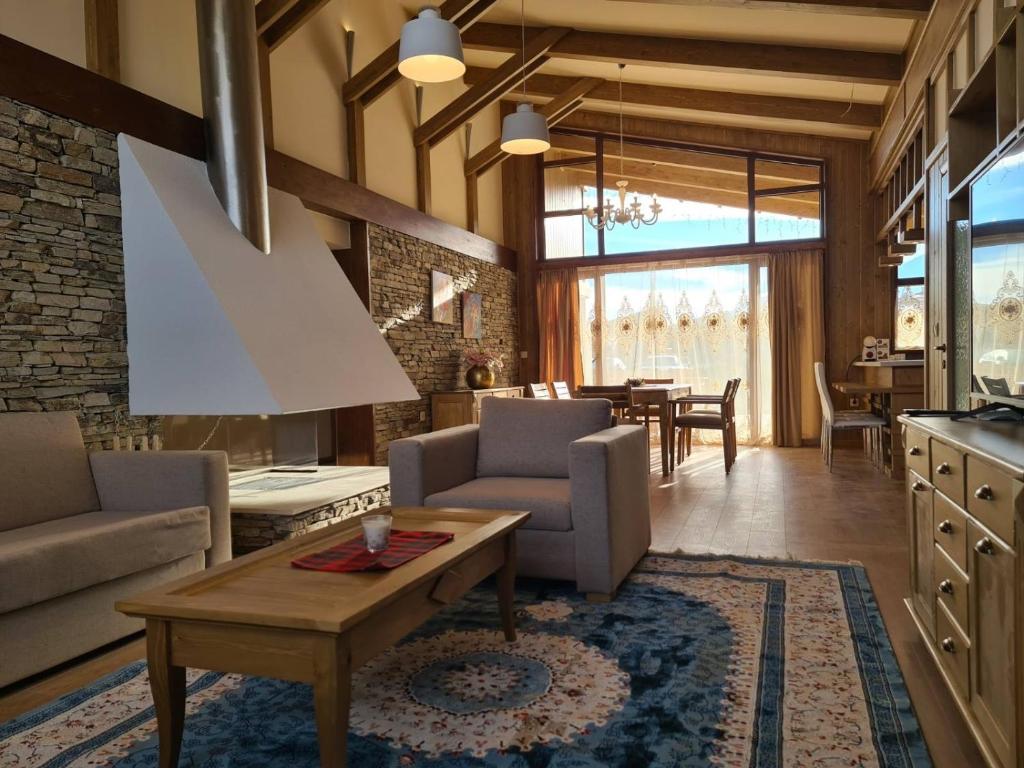 a living room with a couch and a table at Pirin Golf Villa Compass Property in Bansko