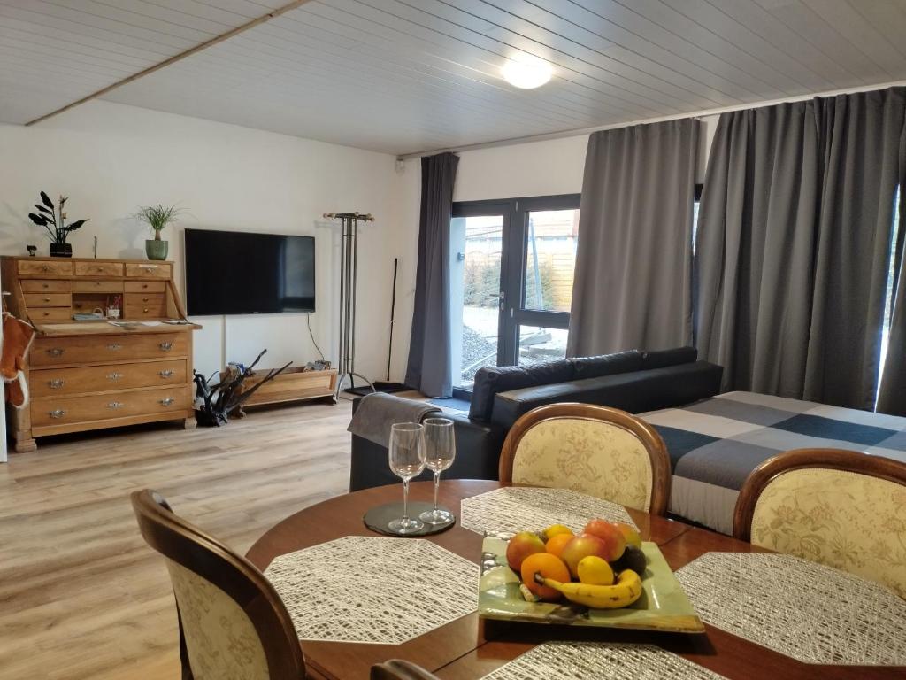 a living room with a table with fruit on it at Spacieux studio 38m2 avec sauna in Les Paccots