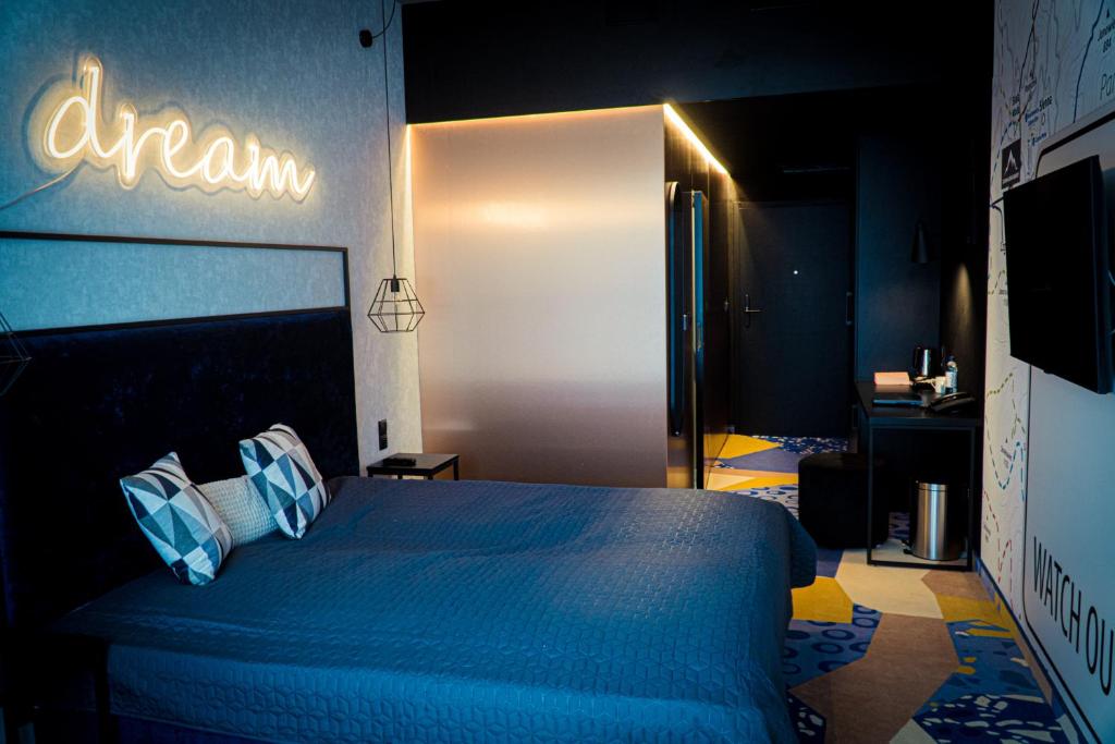 a bedroom with a blue bed with a sign on the wall at Biala Perla Sunny Mountain 602 in Sienna