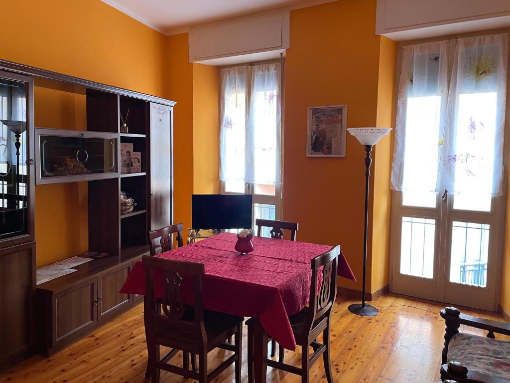 a dining room with a table with a red table cloth at B&B Rosa Apartment in Baveno