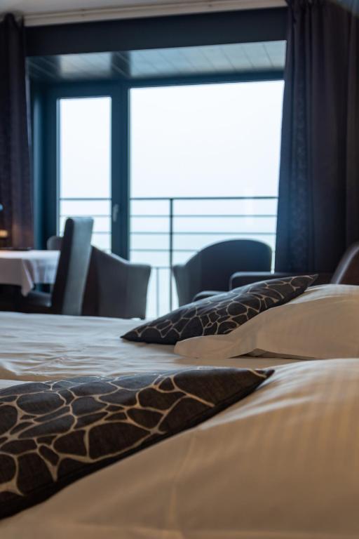 Postel nebo postele na pokoji v ubytování Hotel Les Mouettes
