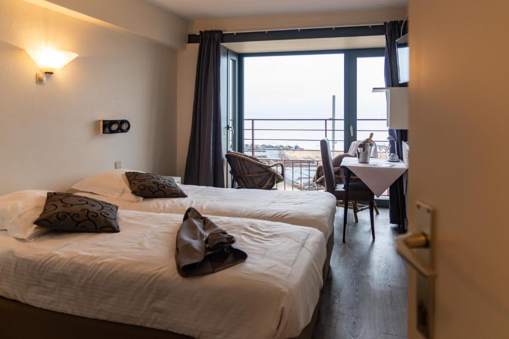 Postel nebo postele na pokoji v ubytování Hotel Les Mouettes