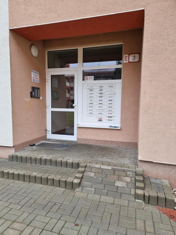 a front door of a building with steps in front at Apartment Banska - City Centre & Free Parking in Banská Bystrica