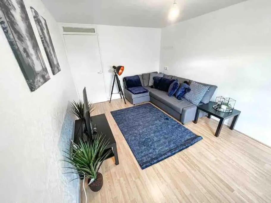 a living room with a couch and a table at Spacious Two Bedroom flat in Hither Green