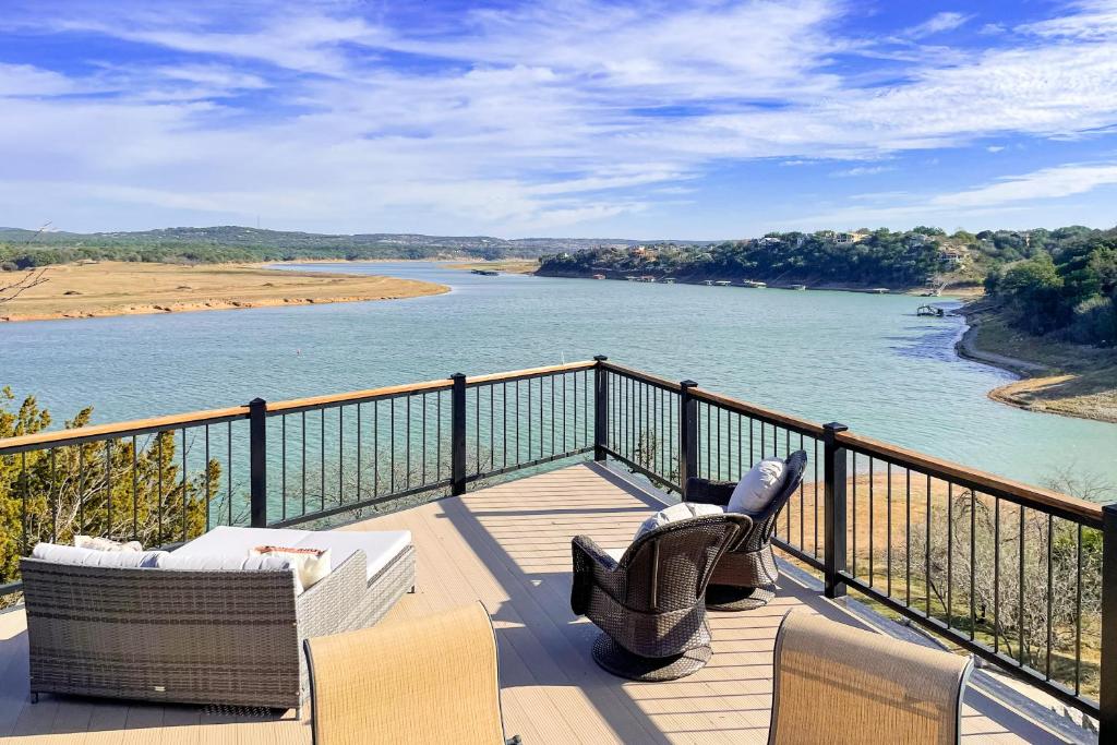 a balcony with chairs and a view of a river at Stone Lodge in Spicewood
