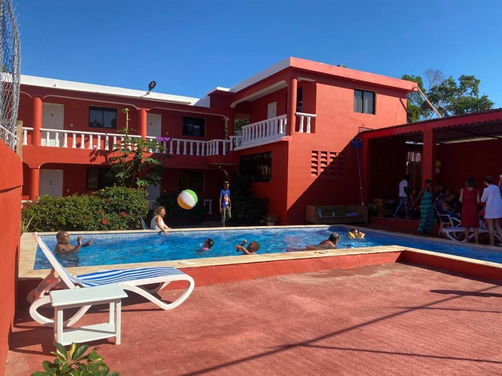 a group of people in a swimming pool next to a house at Villa KIKI Ensenada in Punta Rucia