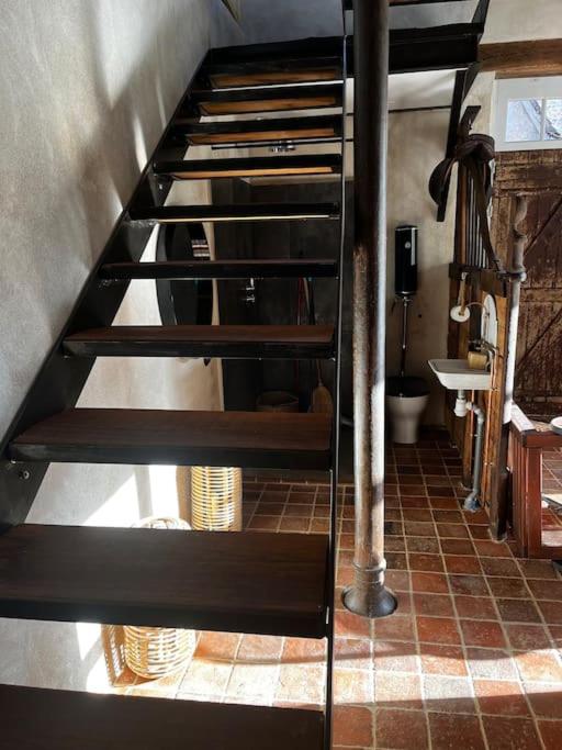 a set of stairs in a kitchen with a sink at Gîte des 3 Marchands in Buzançais