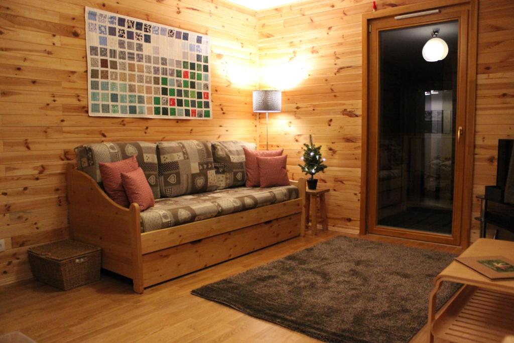a living room with a couch in a wooden wall at Lovely spacious apartment (+garage) in La Plagne in Plagne 1800