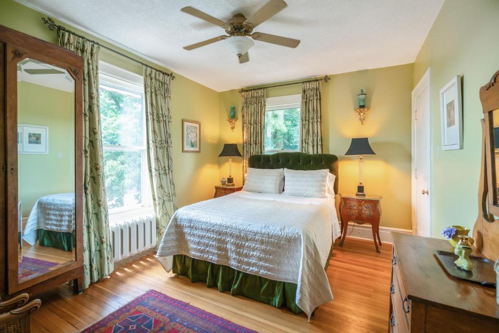 a bedroom with a bed and a ceiling fan at Lion's Head B&B in Niagara Falls