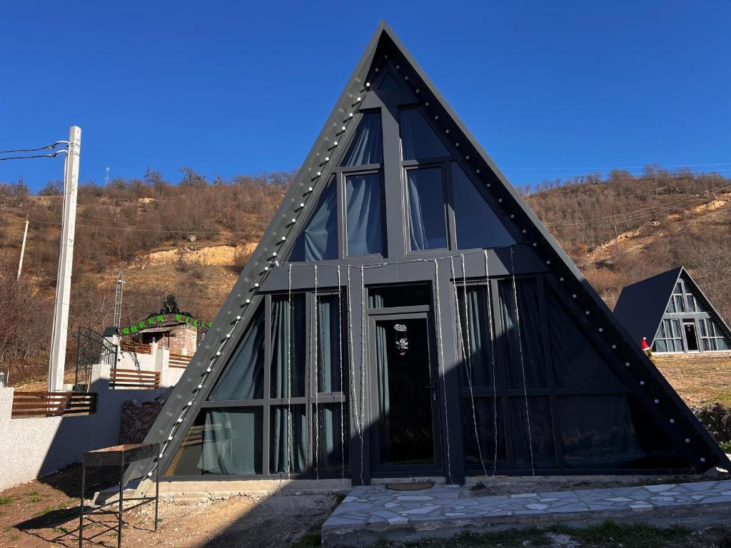 a black house with a triangular roof at Green Villa Resort Small Gray in Dilijan