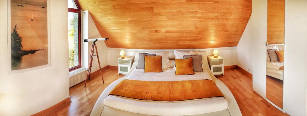 ein Schlafzimmer mit einem großen Bett und einer Holzdecke in der Unterkunft Unique - villa spacieuse en front de mer - with seaview - Kermagen in Pleubian