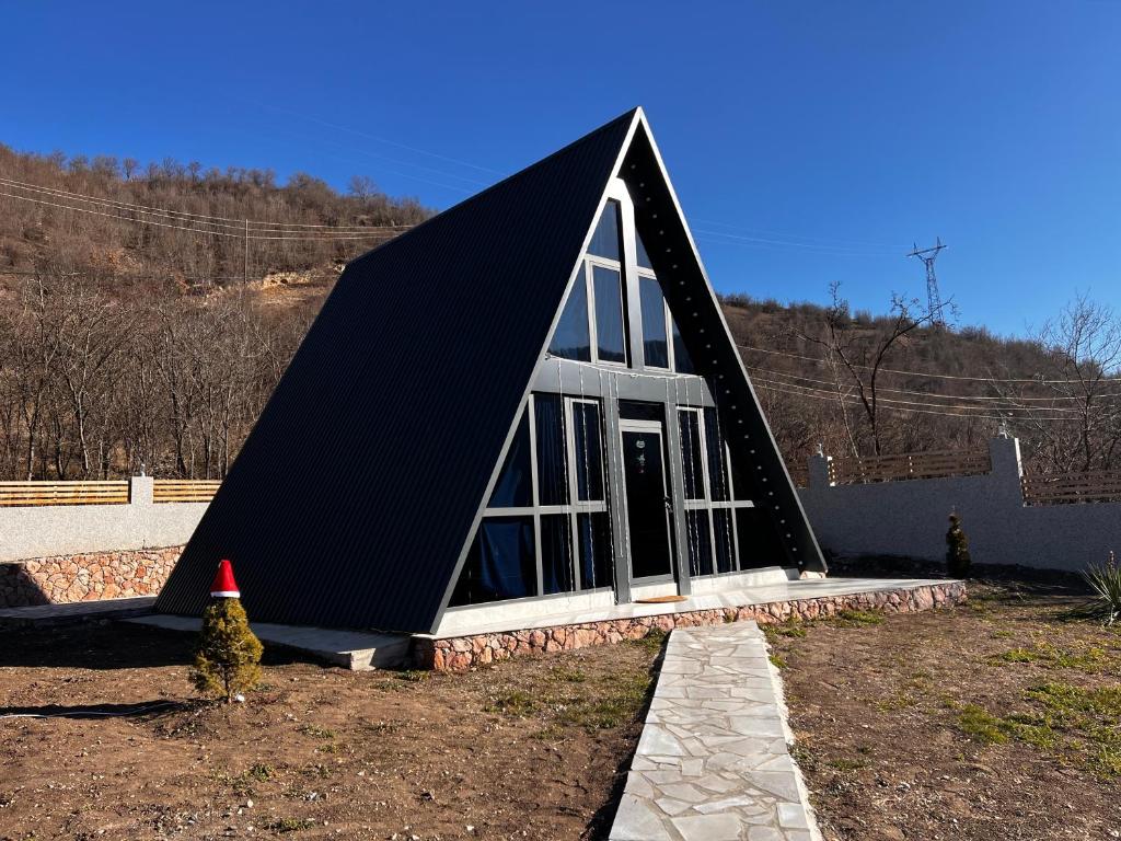 a triangular house with a cone next to it at Green Villa Resort Blue in Dilijan