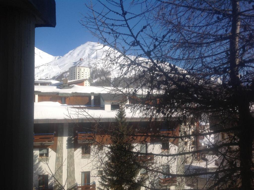 a building with a snow covered mountain in the background at Casa Glesia in Sestriere