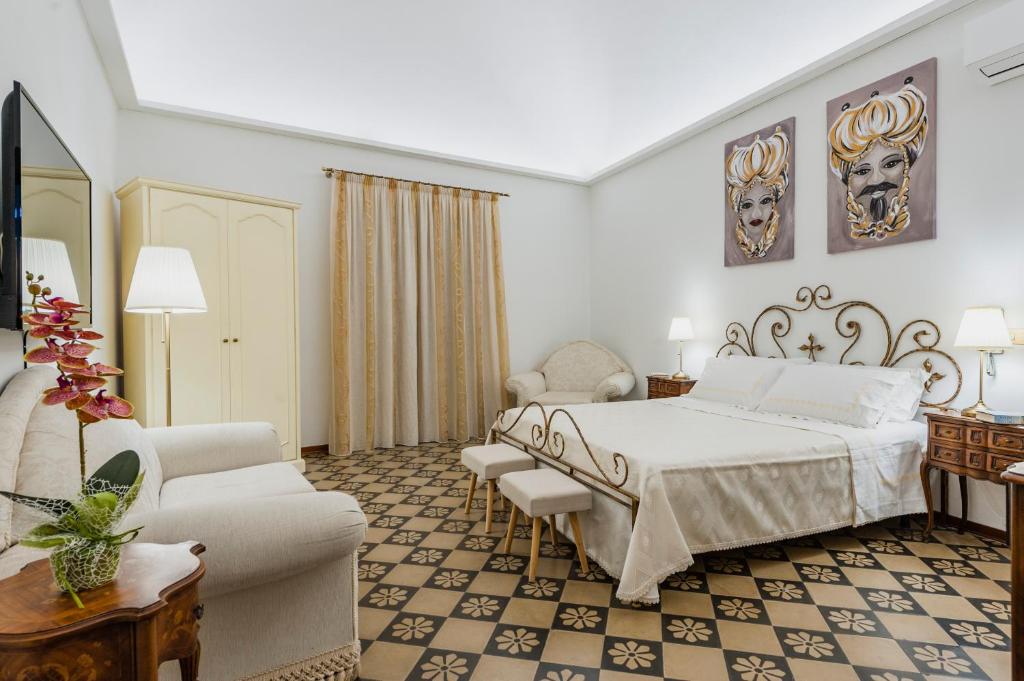 a hotel room with a bed and a couch at centro, stile siciliano, balconi e terrazzino interno parcheggio Alfycodindia in Catania