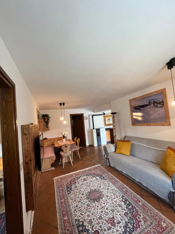 a living room with a couch and a table at Dolomitihouse ZIRMOL in Fiera di Primiero