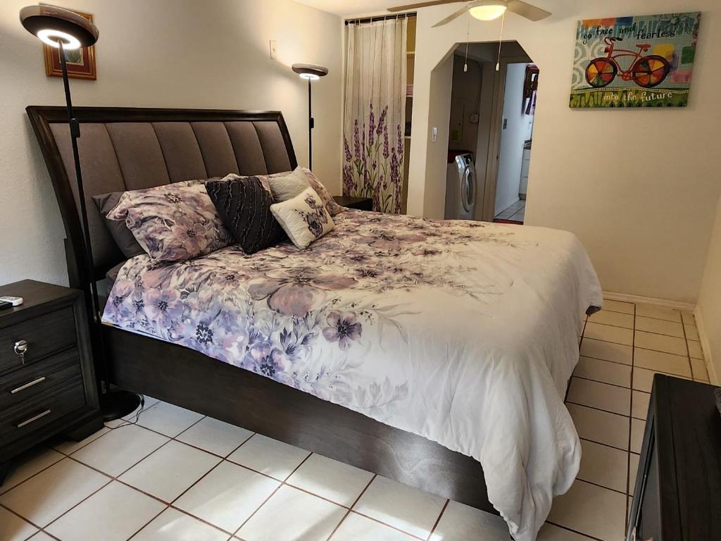 a bedroom with a large bed with flowers on it at Butterfly Ranch in St. Petersburg