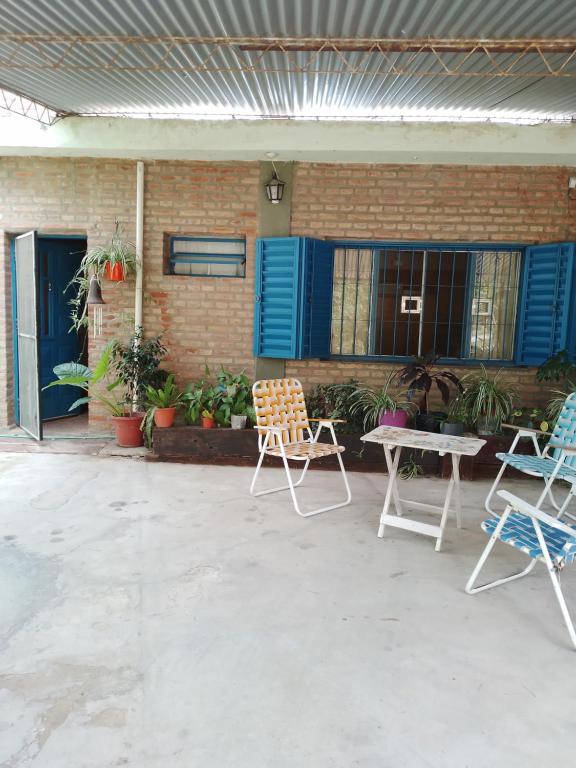 eine Terrasse mit 2 Stühlen, einem Tisch und einem Gebäude in der Unterkunft La Guarida in La Bolsa