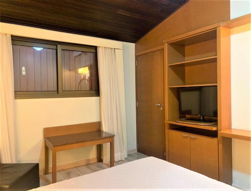 Postel nebo postele na pokoji v ubytování Flat em Gramado